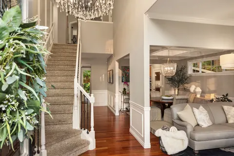 Entry hall with wainscoting opening to the formal living room