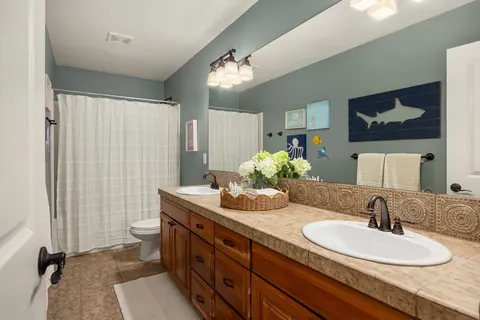 Full bath with extended vanity and tub shower