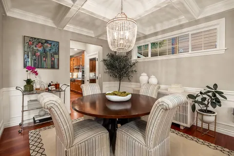 Dining room with coffered ceiling detail and chandelier