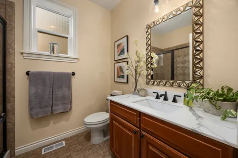 Refreshed three-quarter bath with framed mirror
