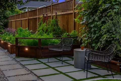 Raised garden beds beside the paver patio seating area
